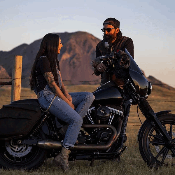 Couple Chatting Near a Motorcycle